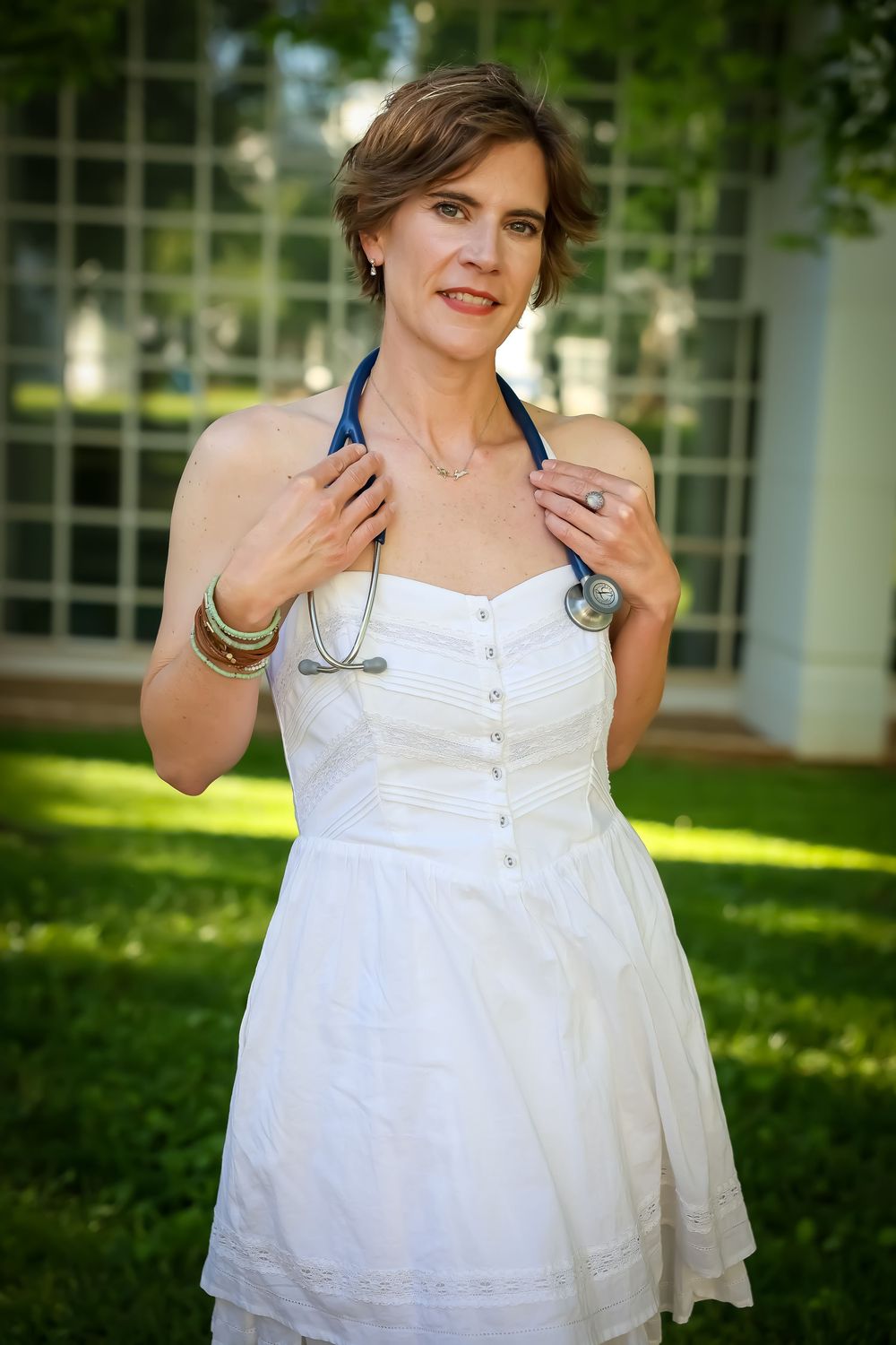 A series of outdoor photos showing someone in a white summer dress against a sunlit garden background.