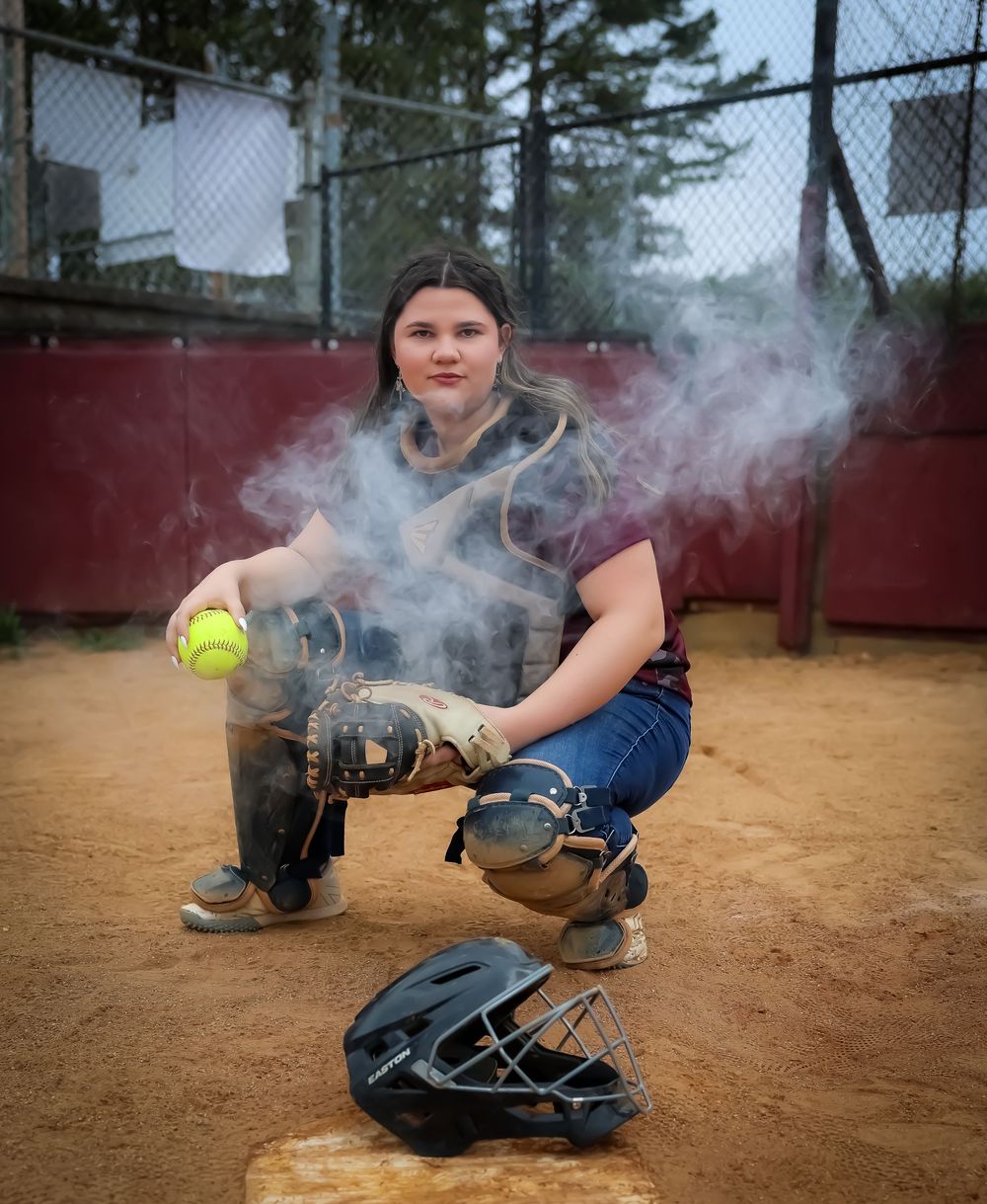Action shots with softball equipment and smoke effects on a dirt field.