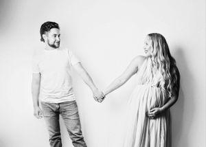 A series of romantic maternity photos showing a couple in white and casual outfits against a light background.
