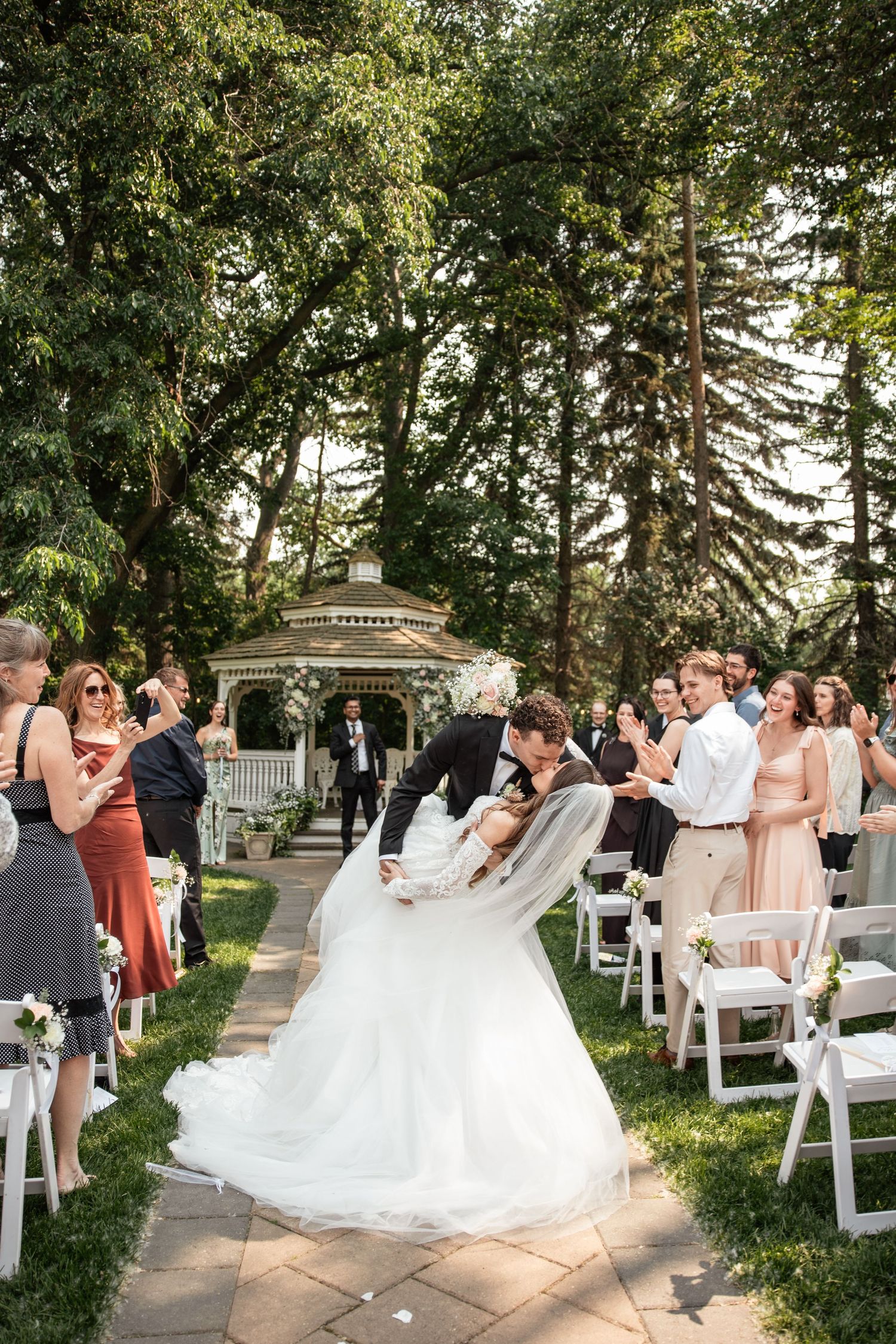 Bride and groom kiss and dip