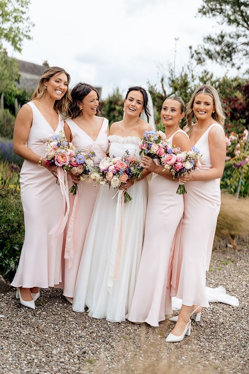 Bridesmaids in pink dresses stand together in Ballymaloe House Wedding Photos by Sarah Kate Photography