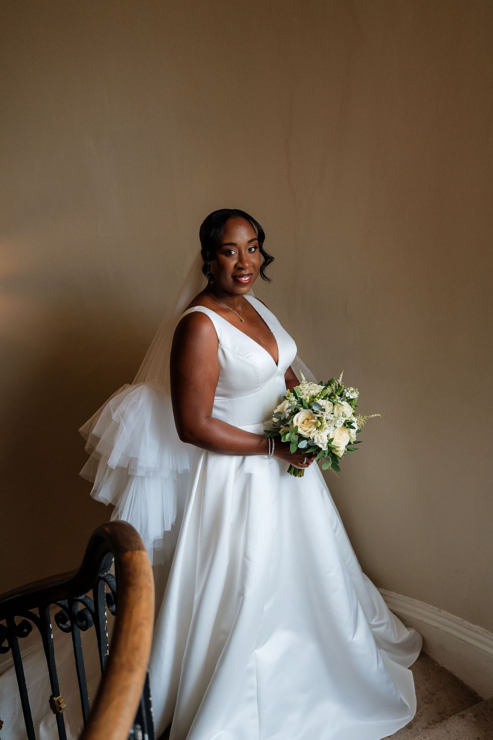 A bride in an elegant white wedding gown in Maryborough House Hotel by Sarah Kate Photography