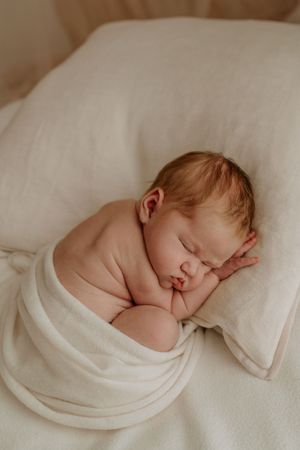 sleeping newborn on pillow at hamilton photography studio