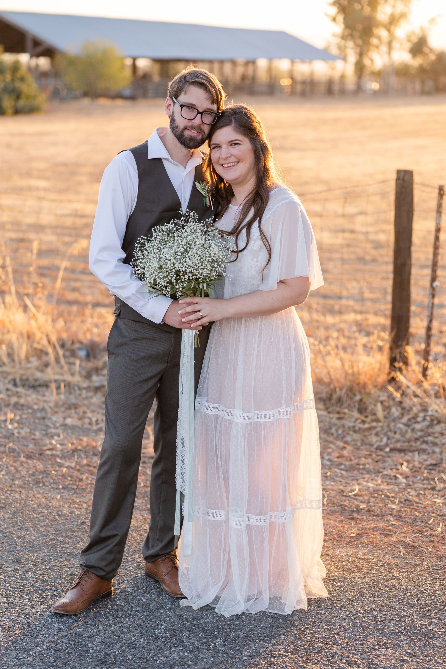 Bride and groom at Orland, California Wedding holding a bouquet