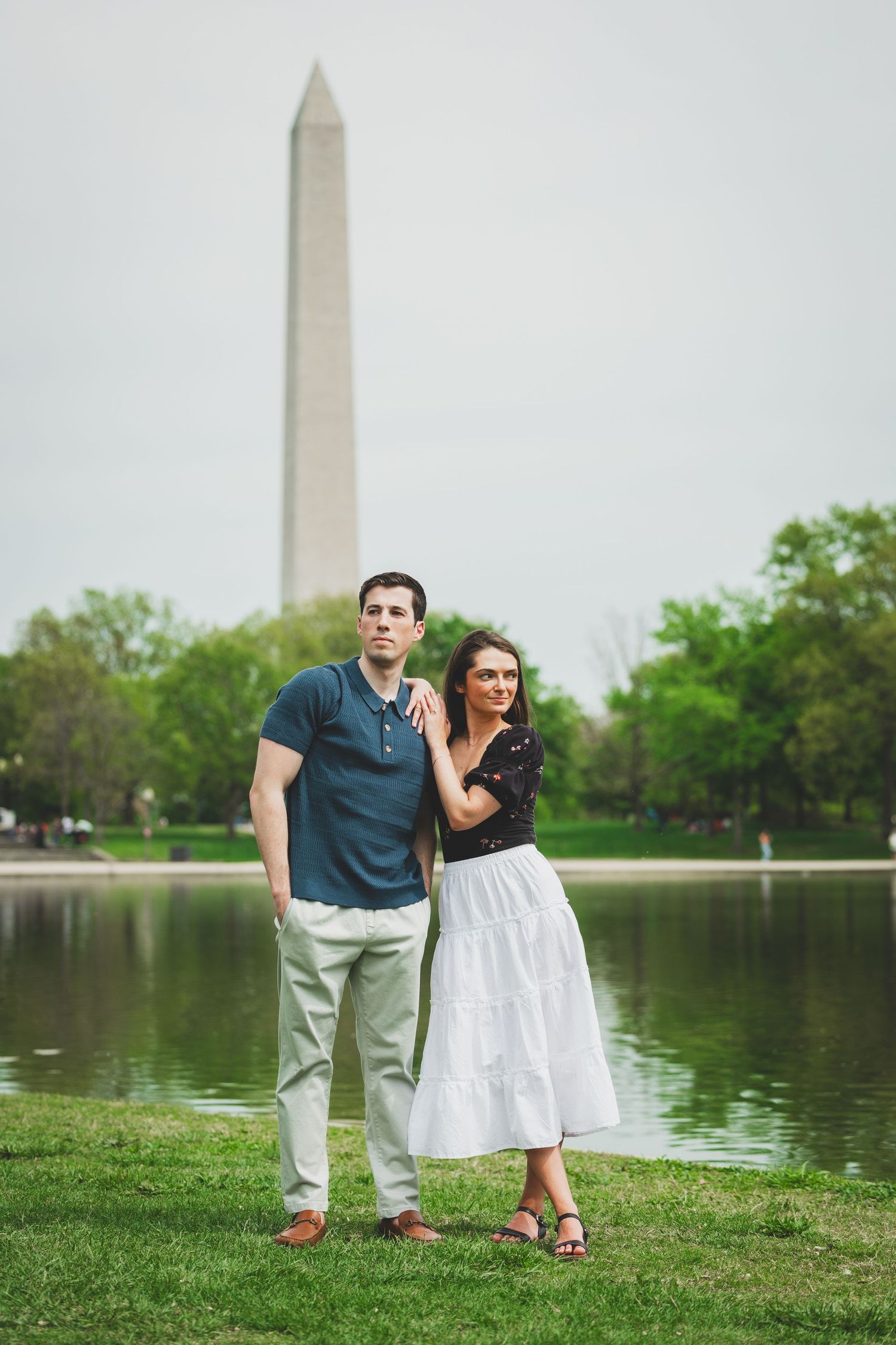 A couple poses at the Constitutional Gardens with the Washington Monument in the background.