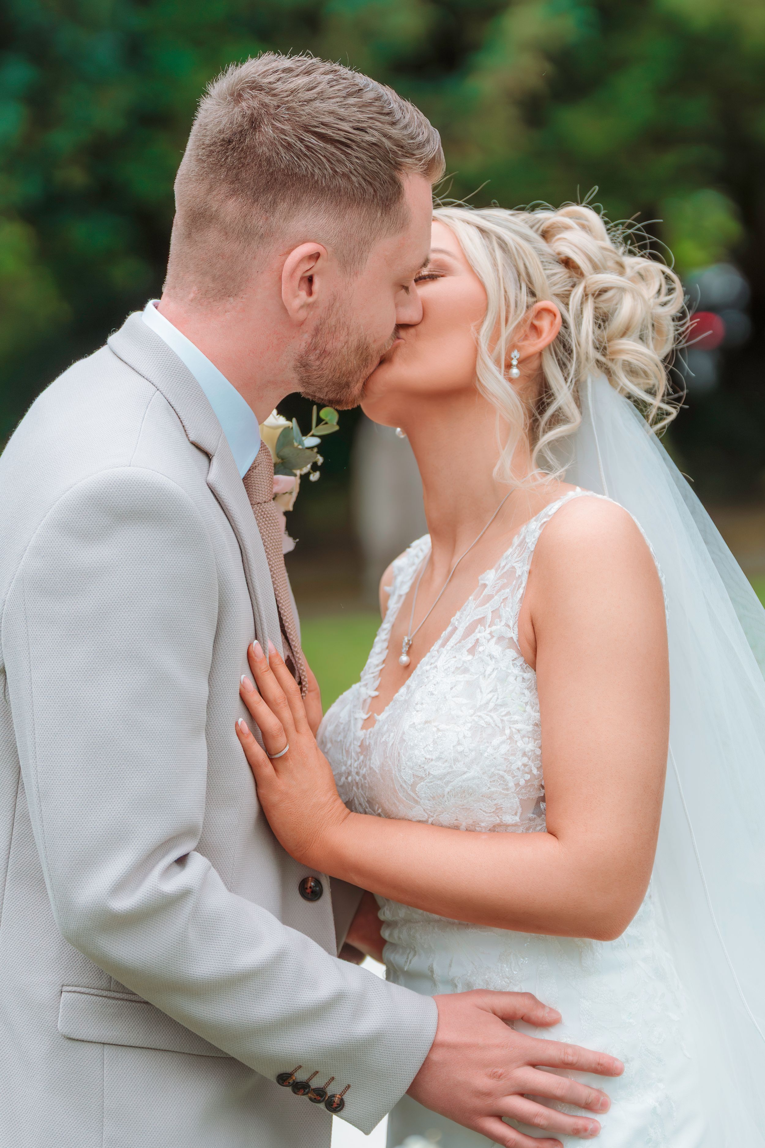 Romantic wedding photos captured under a white gazebo surrounded by greenery.