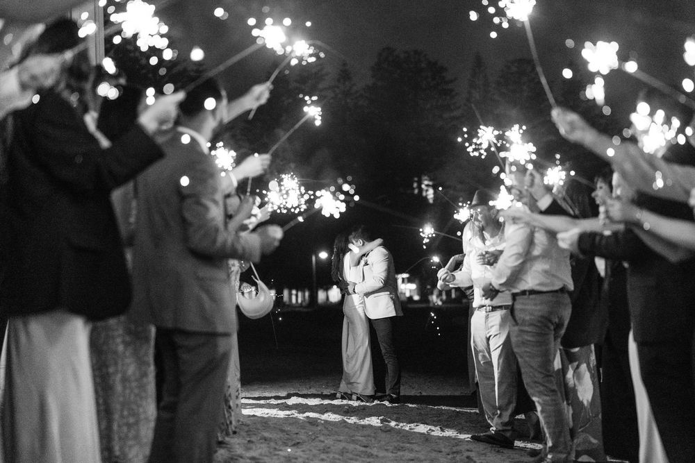 Wedding sparkler exit photo with sparklers creating a magical tunnel of light for the newlyweds at The Baths Sorrento