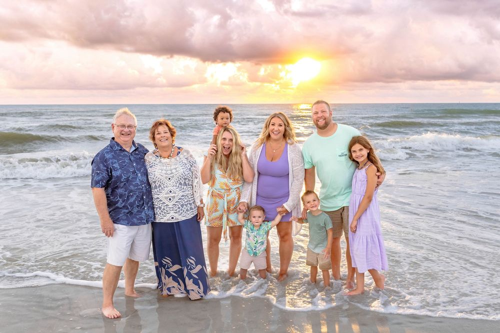 A series of beach family portraits at sunset showing multiple groups posing along the shoreline in coordinated outfits.
