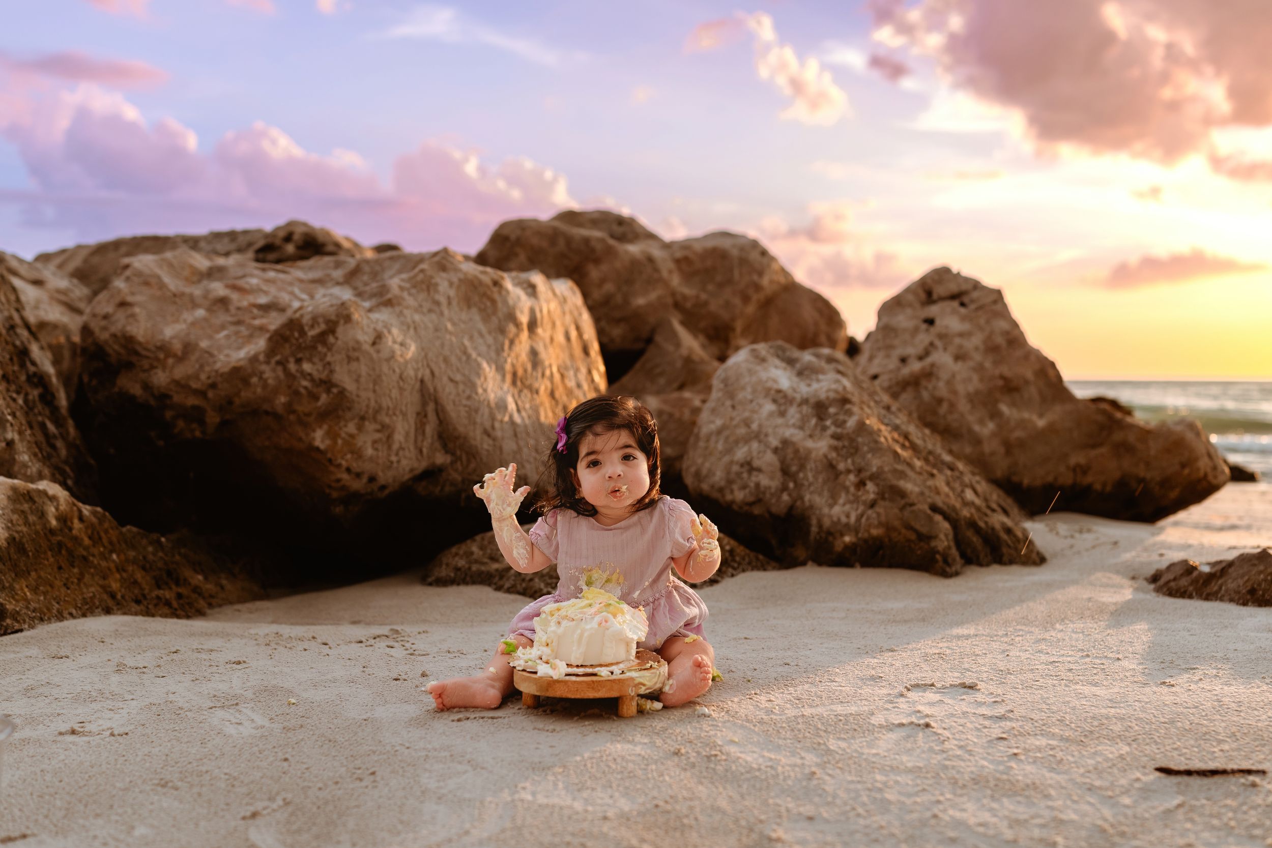 A series of sunset beach photos with large rocks and boulders along the shoreline at golden hour.