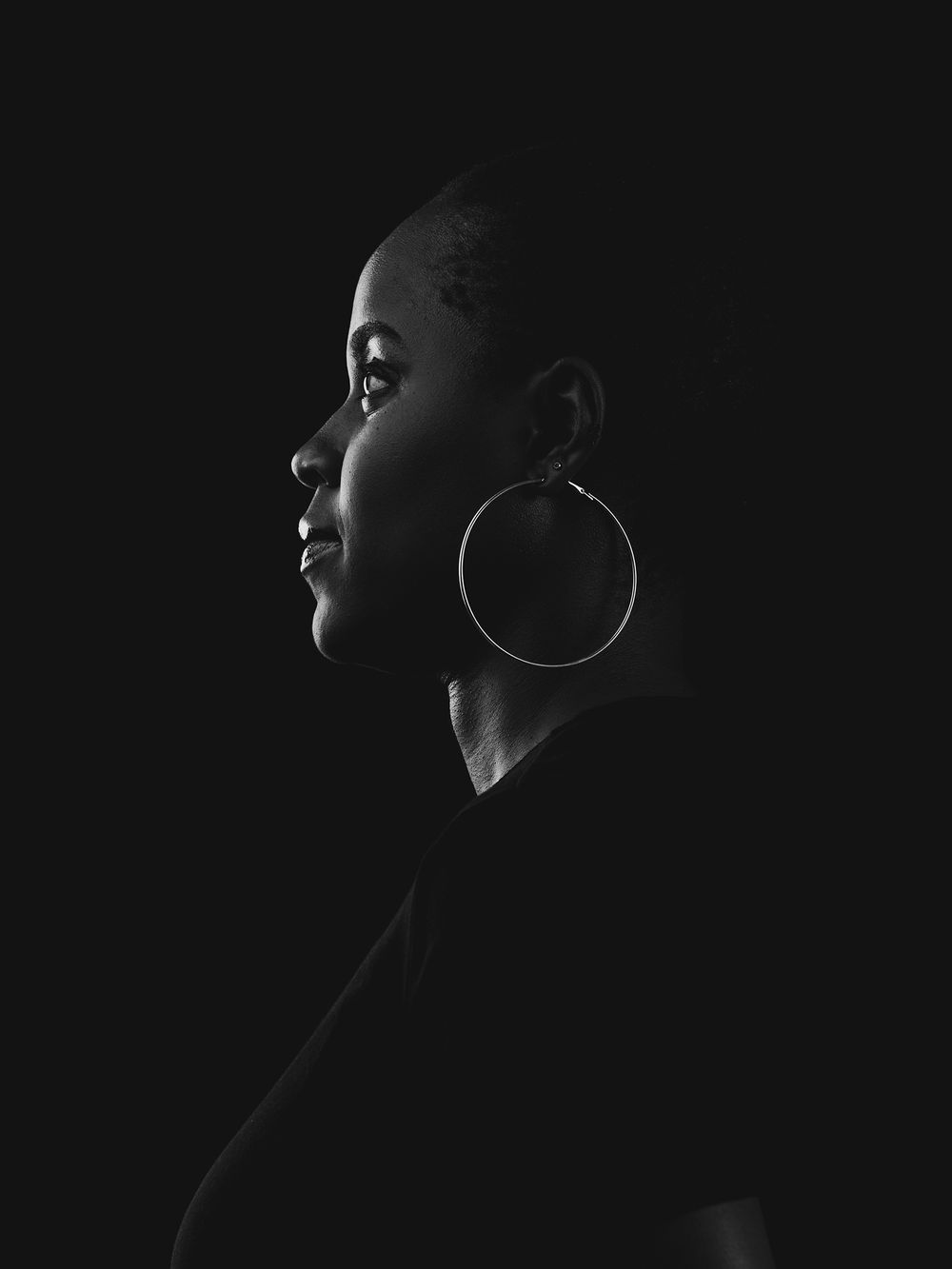 A dramatic black and white profile portrait series showing emotion and angles in moody lighting.