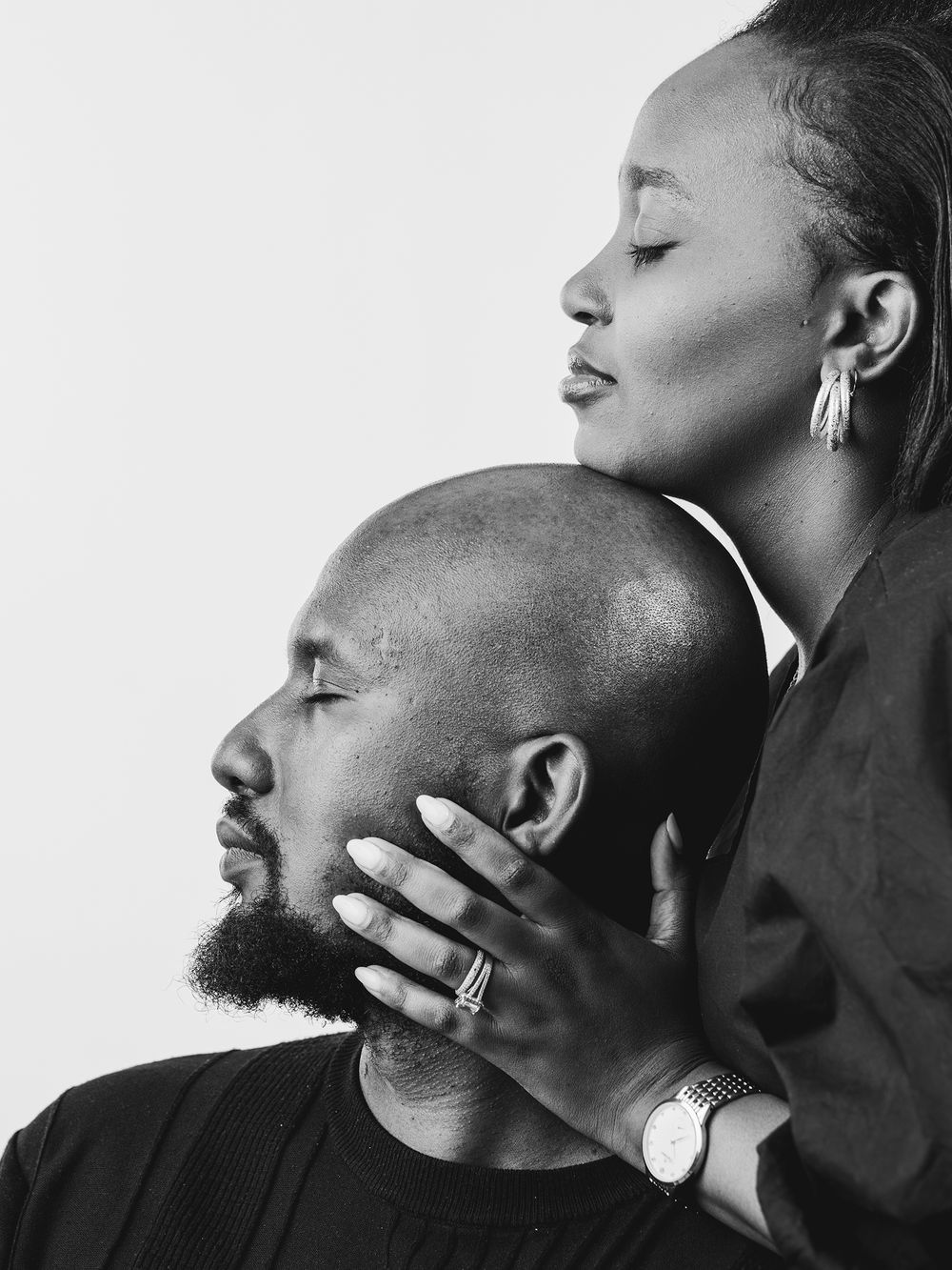 Black and white profile portraits showing an intimate couple whispering and sharing tender moments.