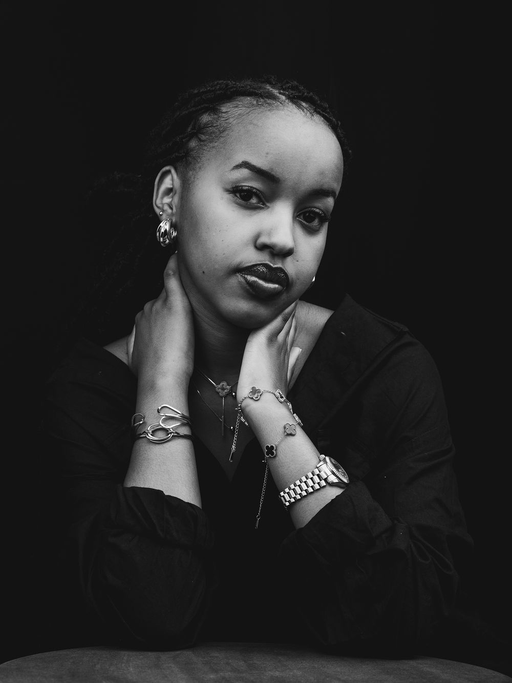 A series of black and white artistic portraits showing a figure posing in different dramatic poses against a dark background.