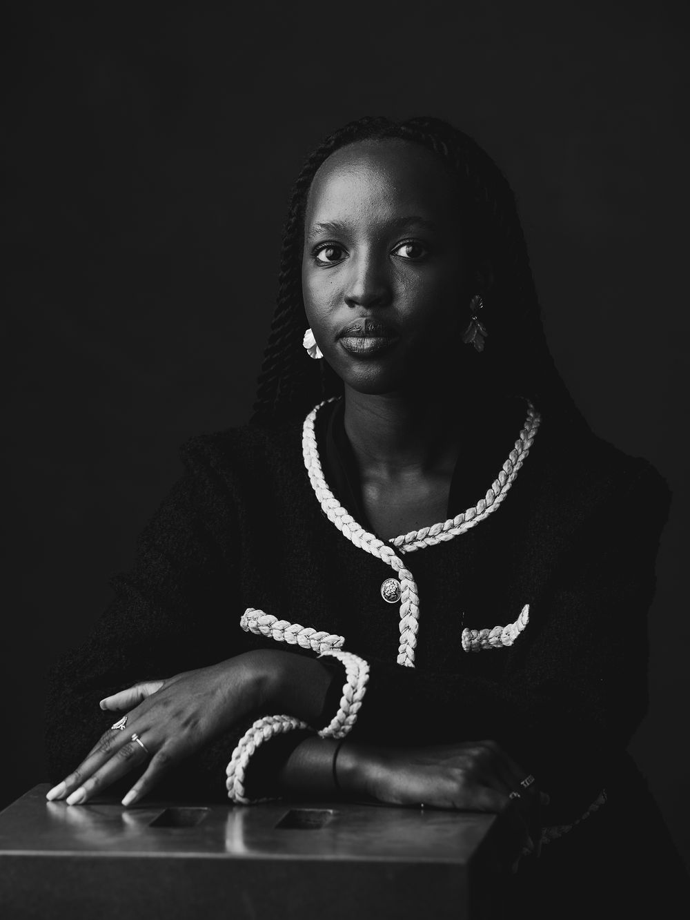 Dark low key portraits with dramatic lighting highlighting white collar on black judicial attire.