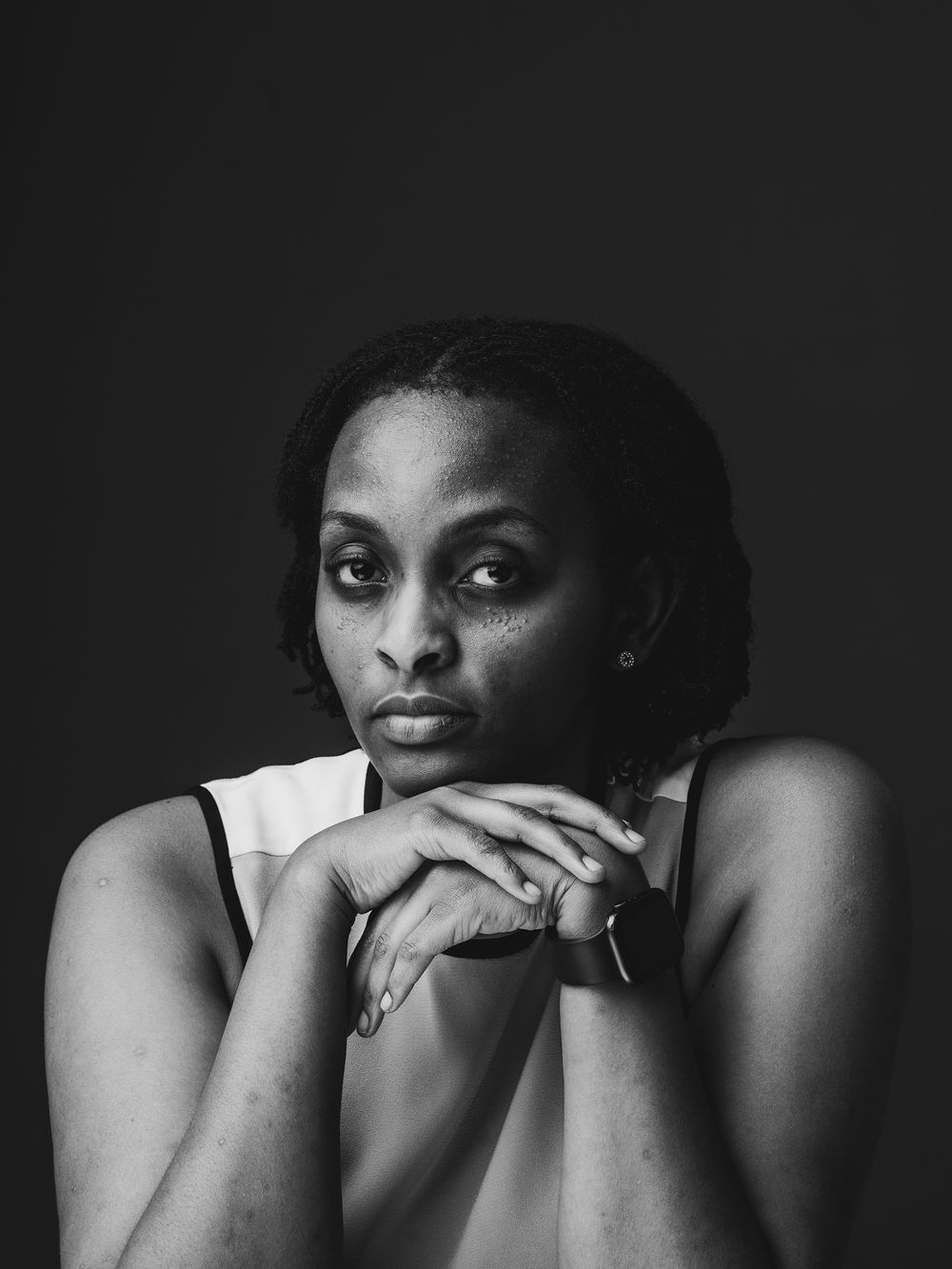 Artistic black and white portrait sequence showing expressive emotions and gestures against dark background.