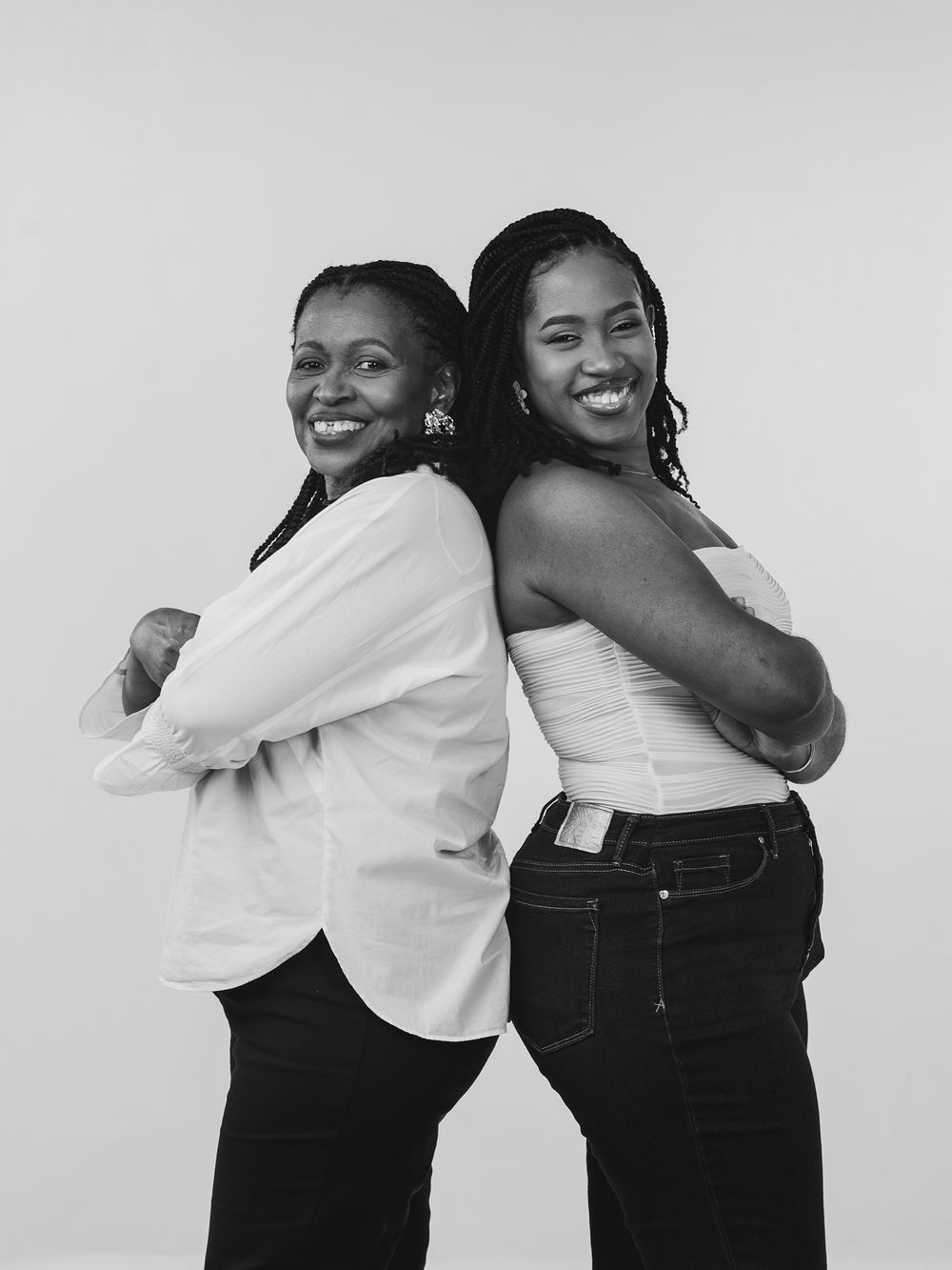A series of four black and white photos showing two people sharing warm embraces and smiling together.