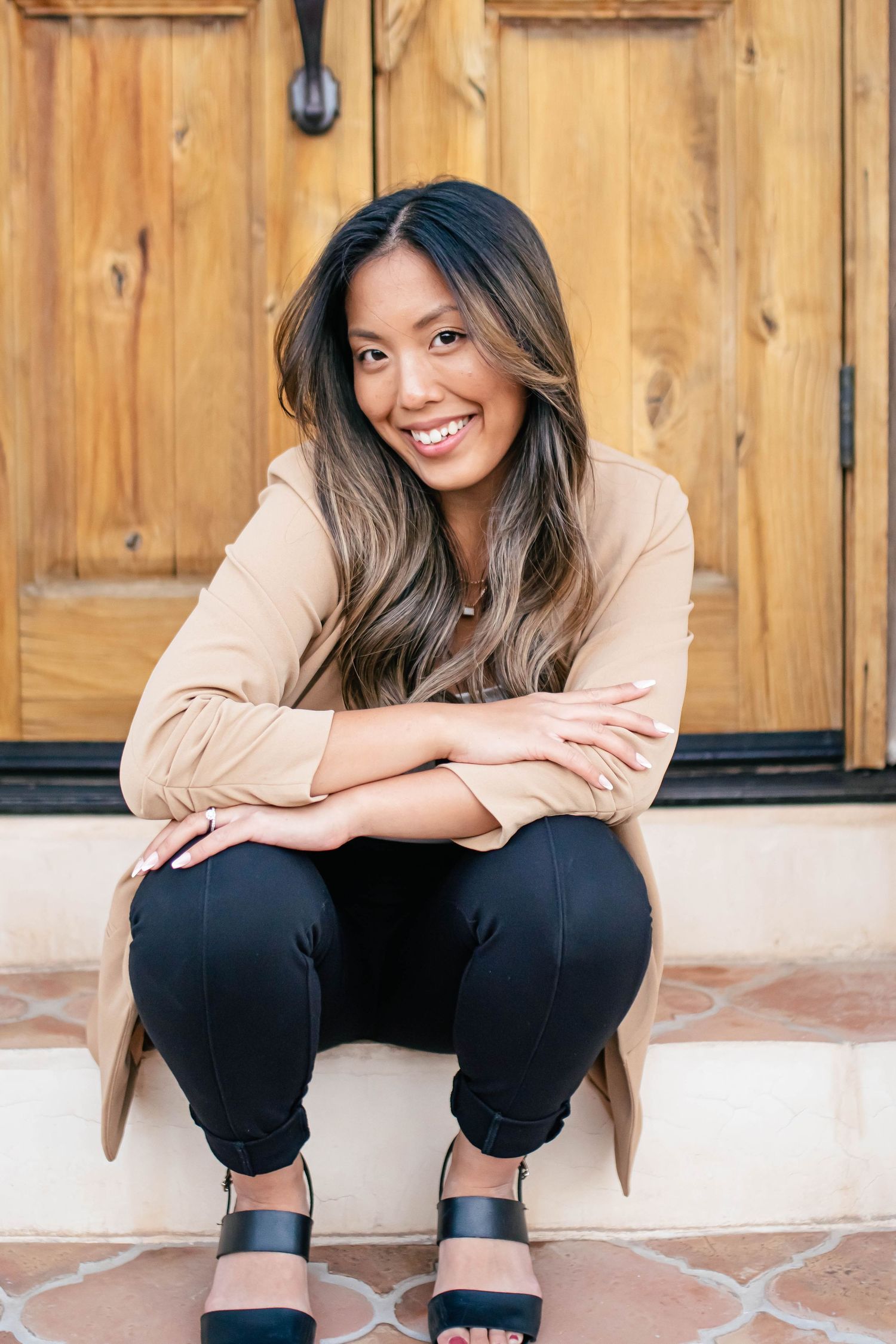 Casual portrait session against wooden paneled wall with natural lighting.