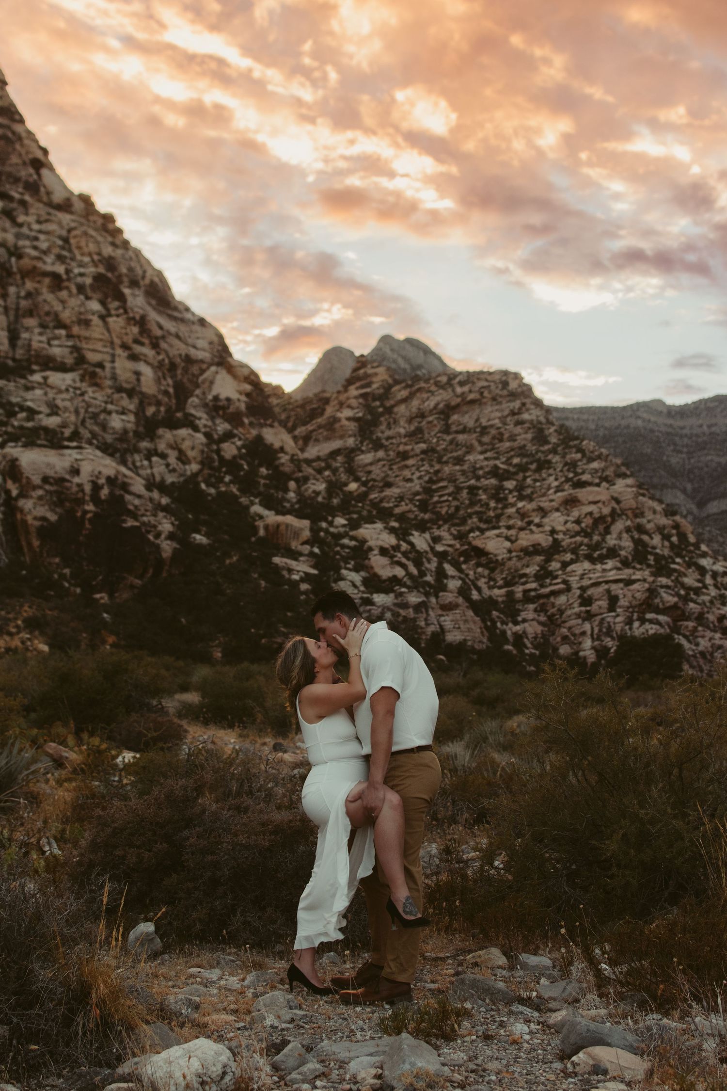 Intimate wedding couple portrait showing detailed floral lace dress and dark suit.