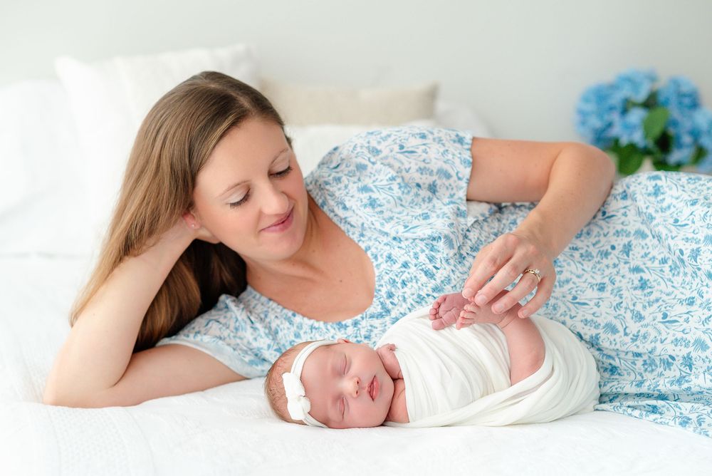 A mother lying on a bed with sleeping baby are shown in a series of intimate bonding moments.