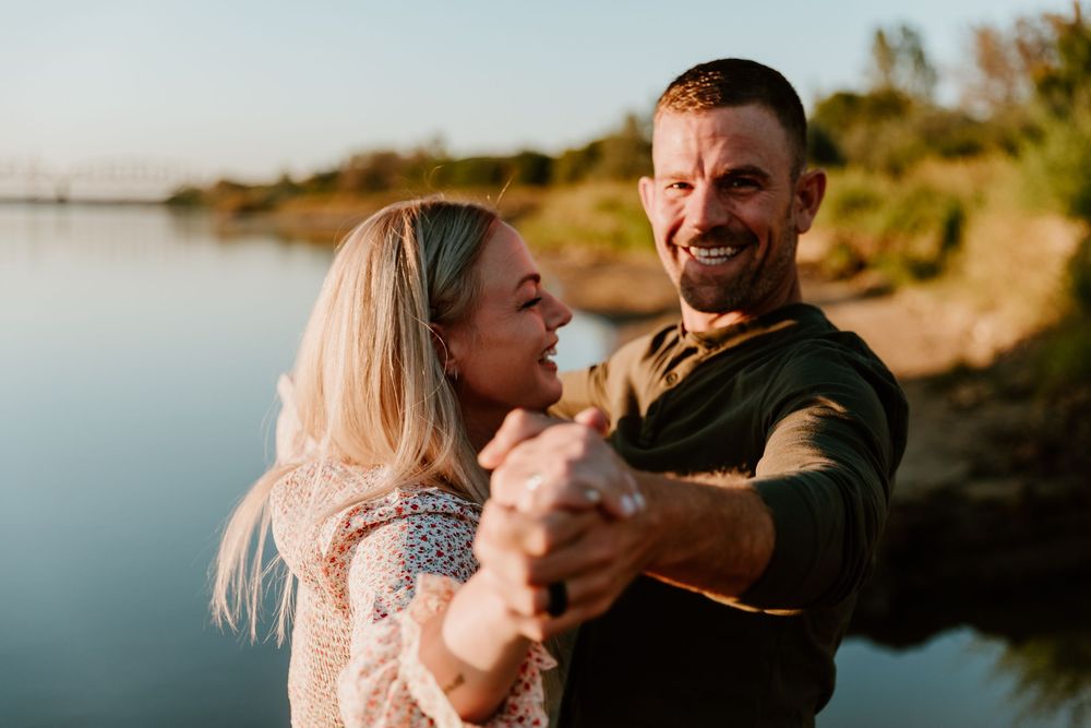Candid family photos captured during sunset by the water's edge.