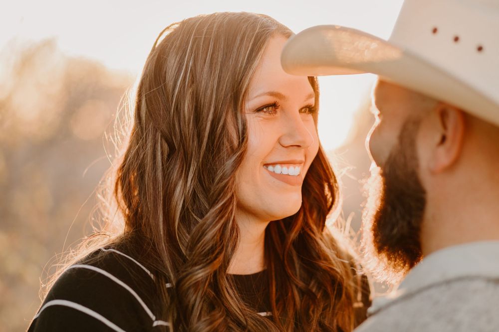 Intimate portrait of couple sharing loving moment during golden hour sunset.