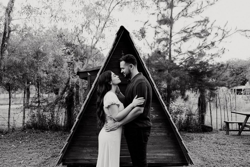 Black and white romantic photos captured against a rustic barn backdrop.