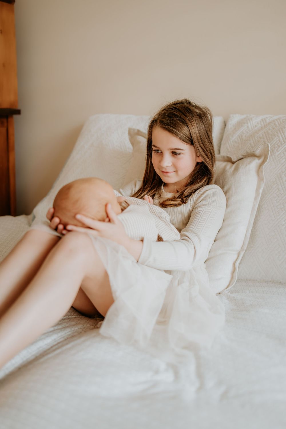 Adelaide newborn photographer - big sister holding newborn baby boys