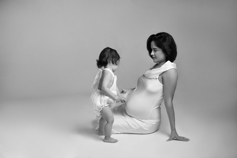 Artistic black and white portraits capturing intimate parent-child interaction.