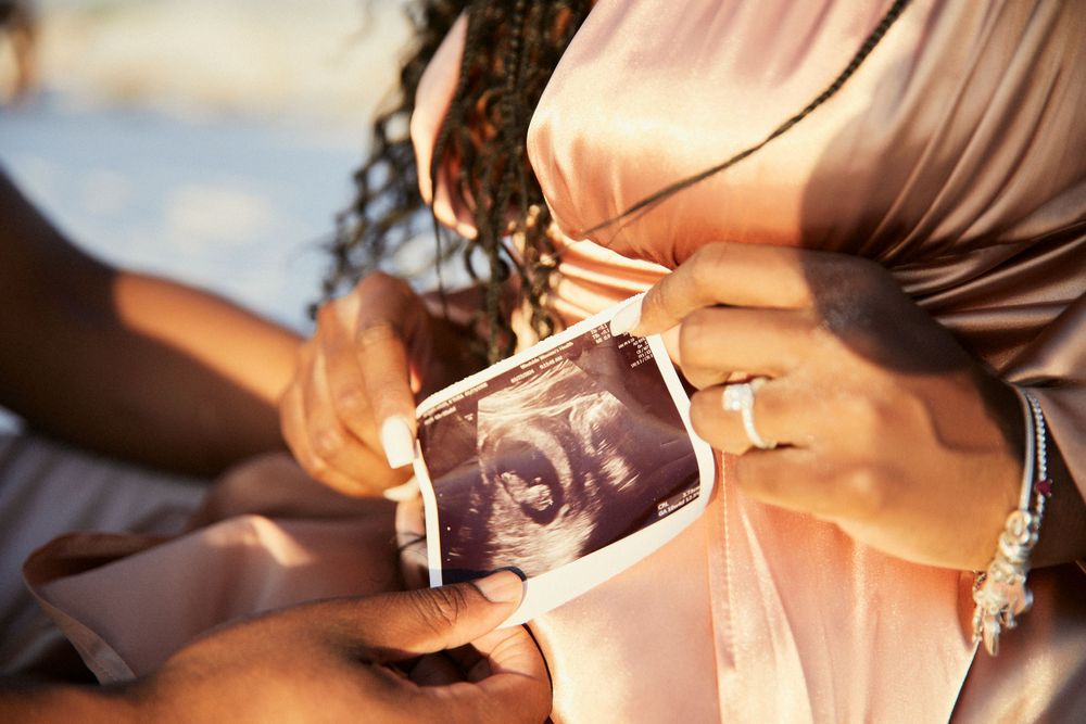 Close-up details of delicate pink and peach toned fabric in natural lighting.