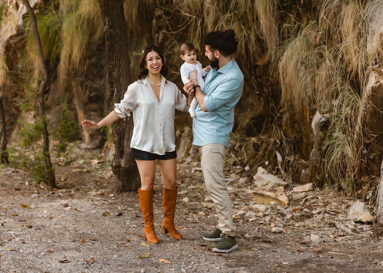 Mum in maxi dress and plaited hair holding baby during Brisbane family photo shoot