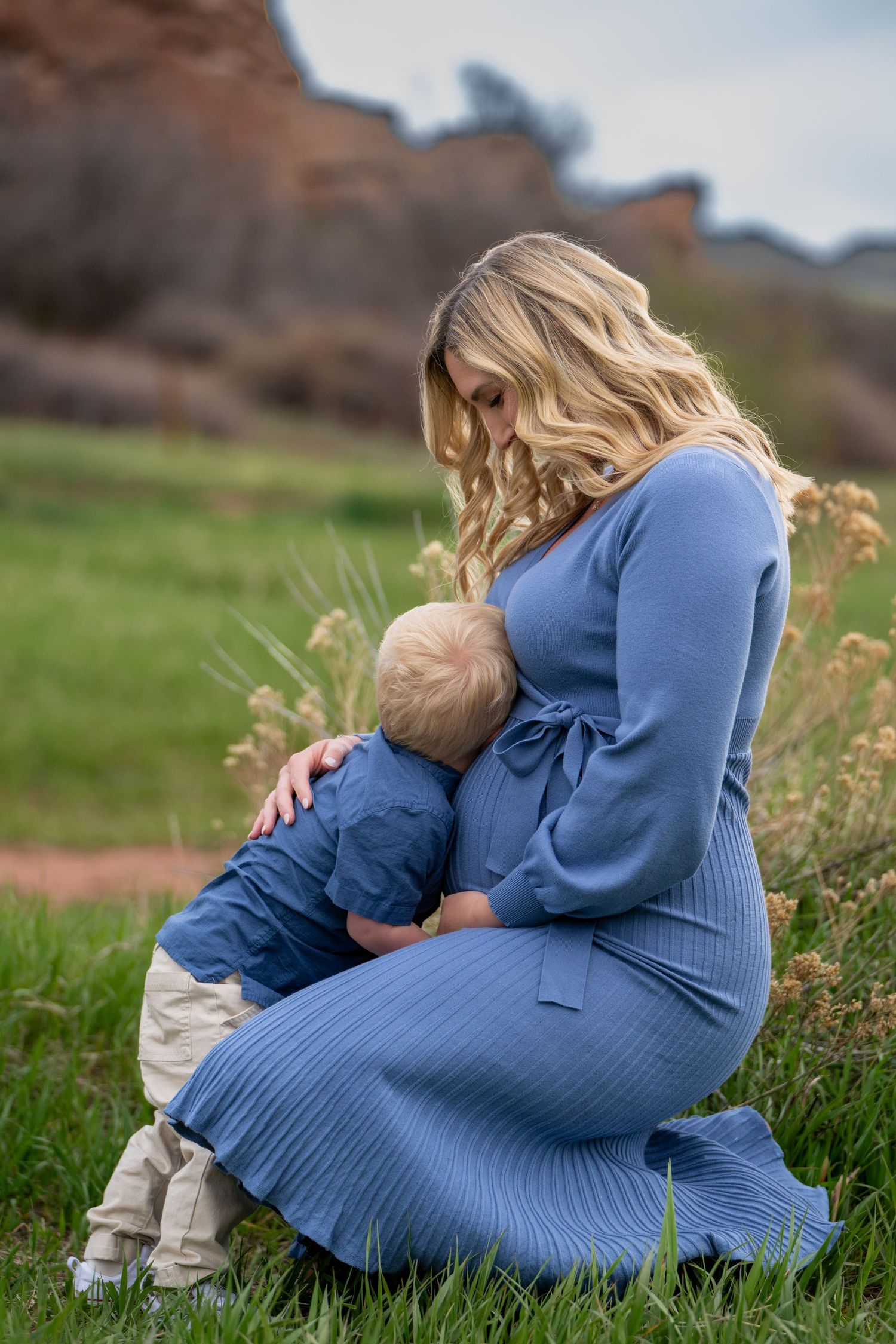 Couple sharing romantic moment while holding positive pregnancy test outdoors.