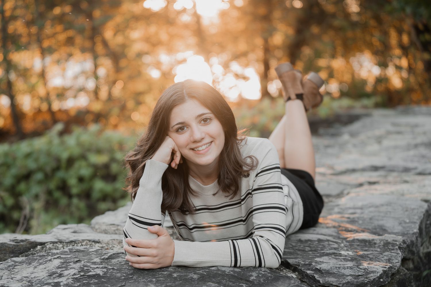 high school senior girl standing among yellow flowers