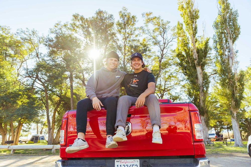 Orange Lutheran High School students on a red truck while on break during an annual mission trip