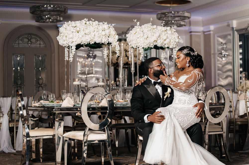 Elegant wedding reception celebration in a luxurious ballroom with crystal chandeliers and ornate decor.