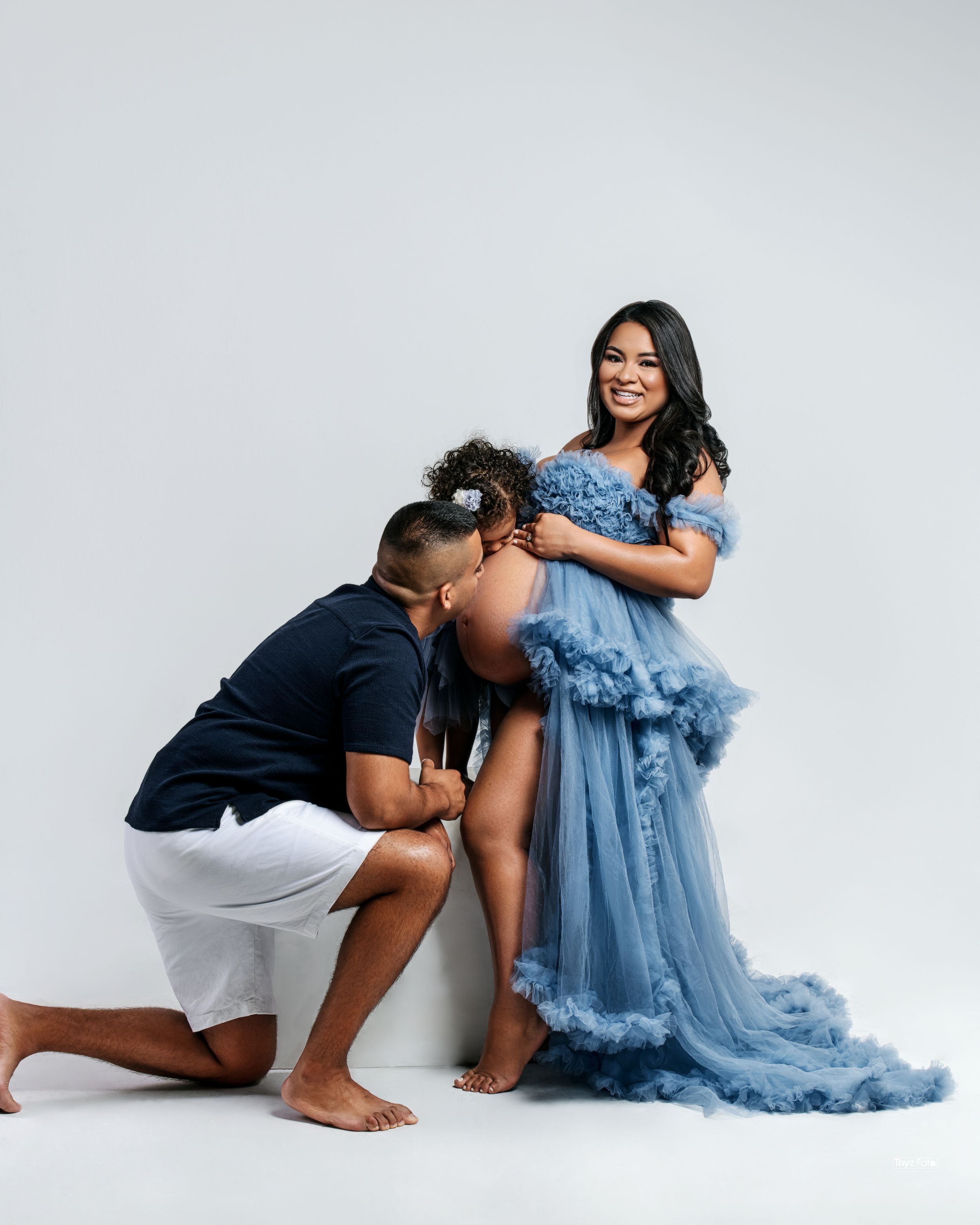 Couples maternity shoot with coordinated outfits, capturing the joy of expecting parents in a timeless setting.