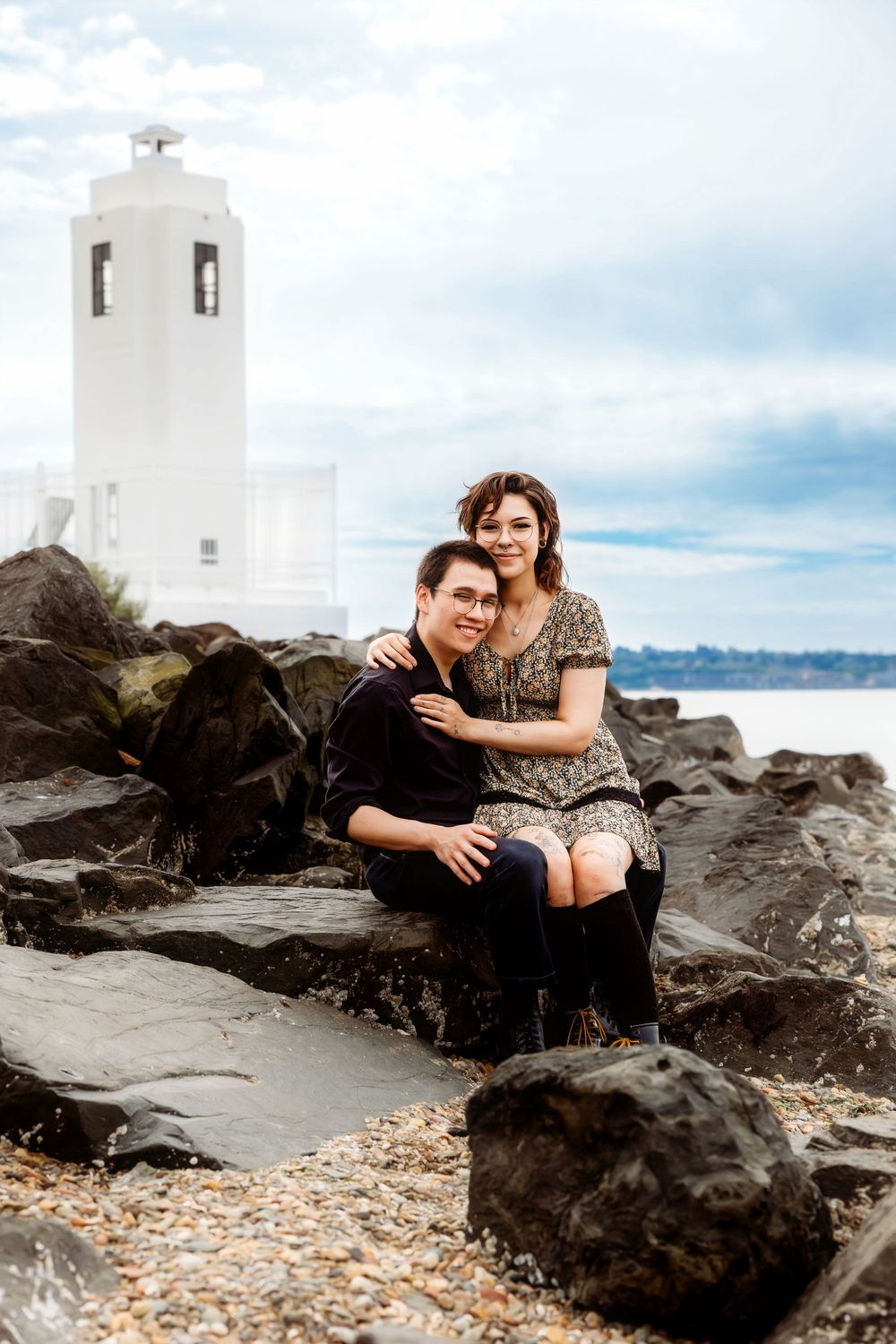 Couples session at rocky beach with lighthouse at Browns Point Lighthouse in Browns Point Washington