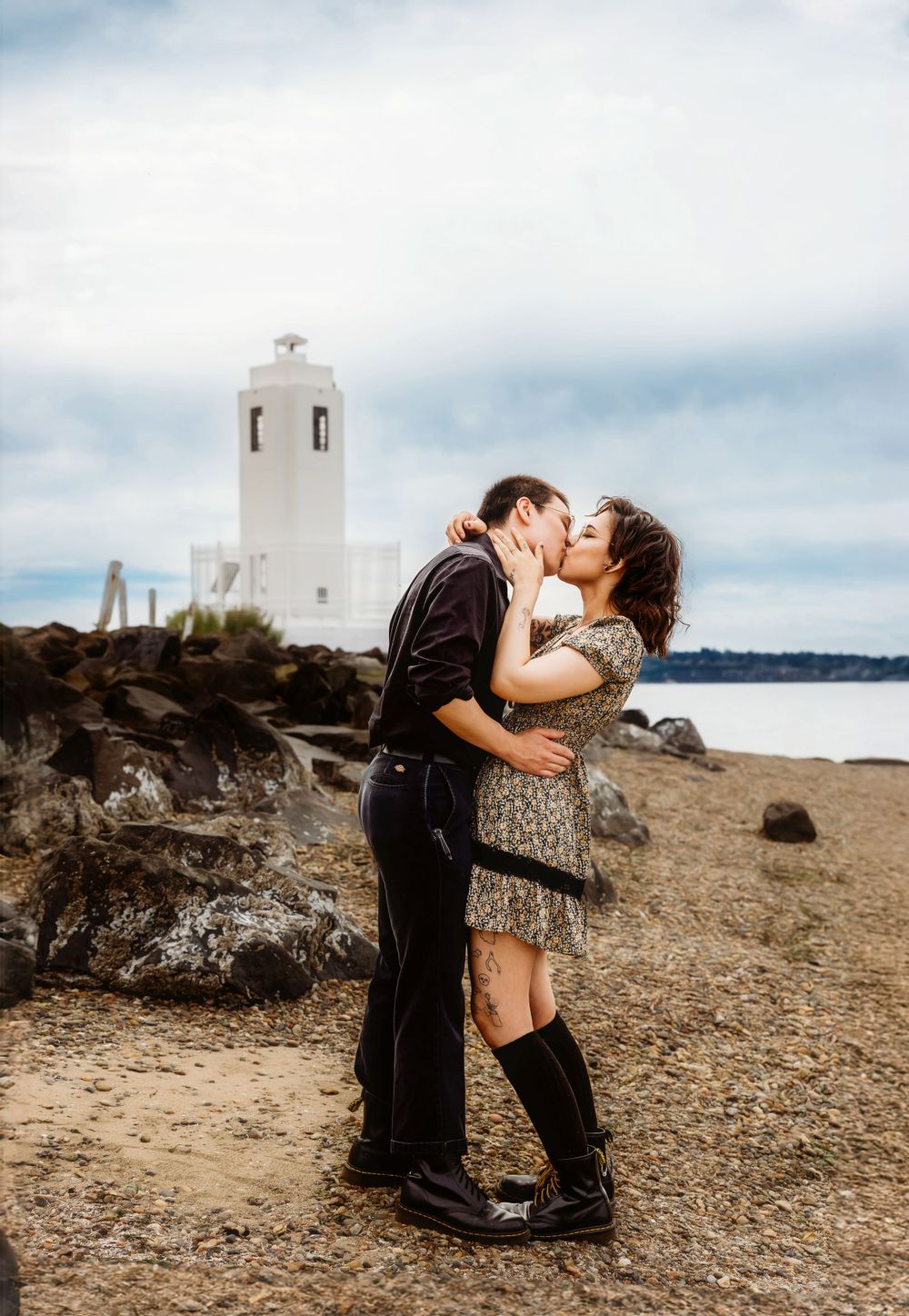 Couples session at rocky beach with lighthouse at Browns Point Lighthouse in Browns Point Washington