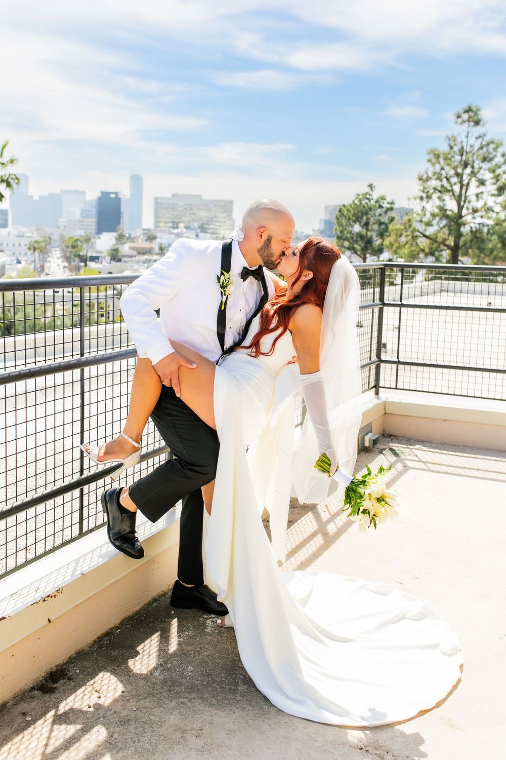 Bride and groom walking kissing on balcony eloping at Beverly Hills Courthouse