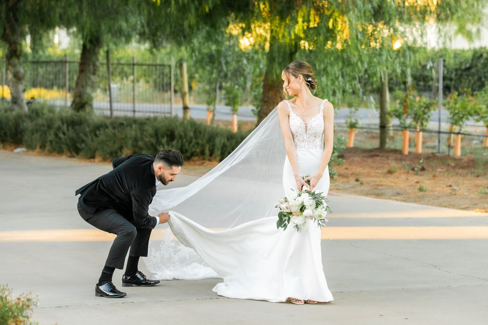Groom fixing his brides veil