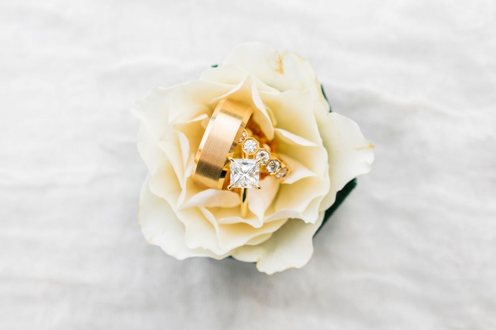 Gold wedding band and diamond ring in a flower