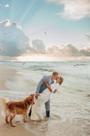 golden retriever on beach with bride and groom couple wedding photographer destination international Greece Italy elope elopement love story