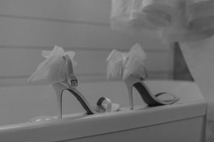 detail shot of shoes with tulle bows in black and white, bride and groom couple wedding photographer destination shoes vibey film