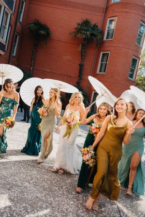 Julianne Drake photography bridal party with parasols with beautiful colorful florals and green dresses Destination wedding europe elope