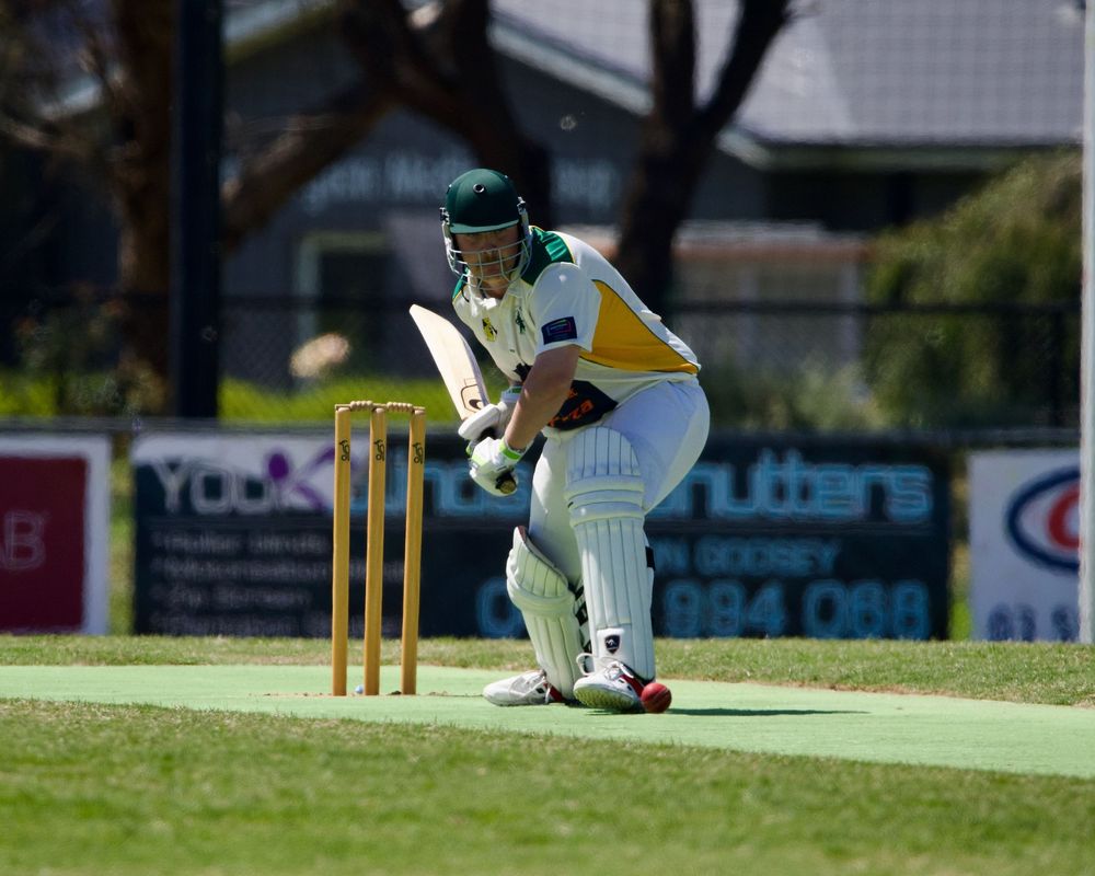 Cricket batsman lining up ball