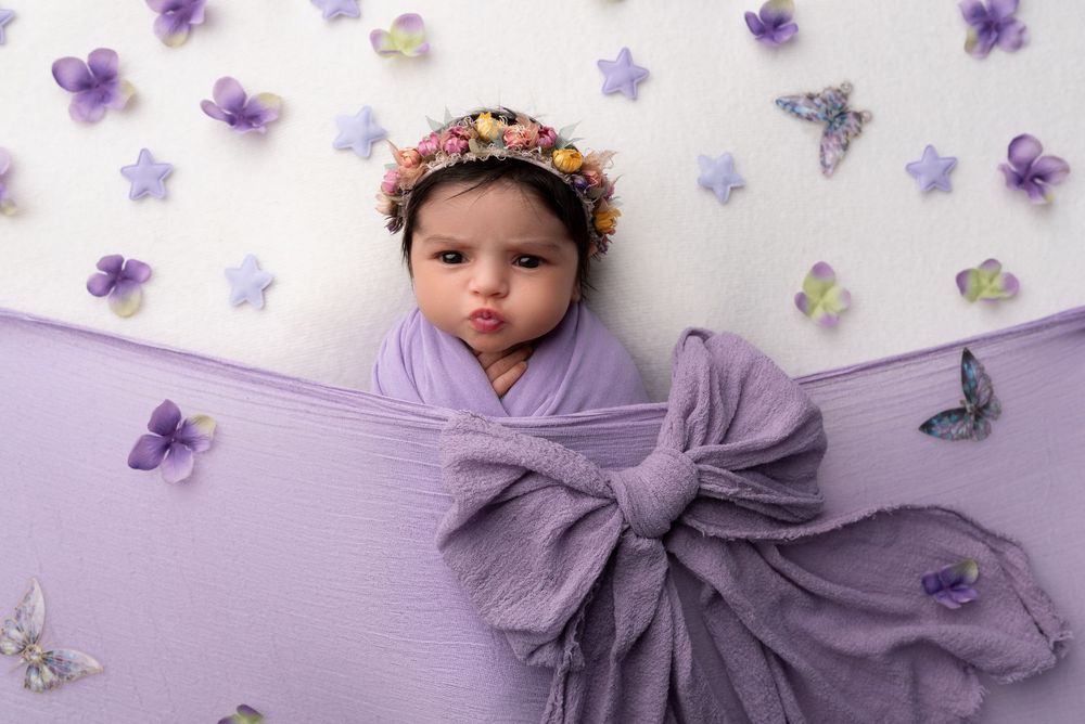 Baby girl in floral headband during newborn session