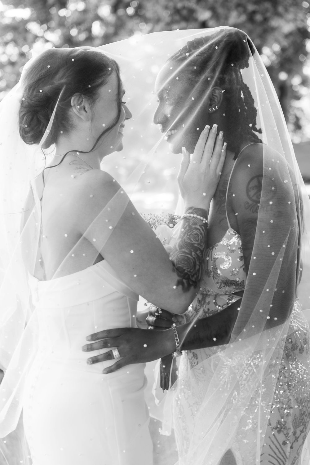 A romantic black and white photo collage showing intimate wedding moments under flowing veils in soft sunlight.