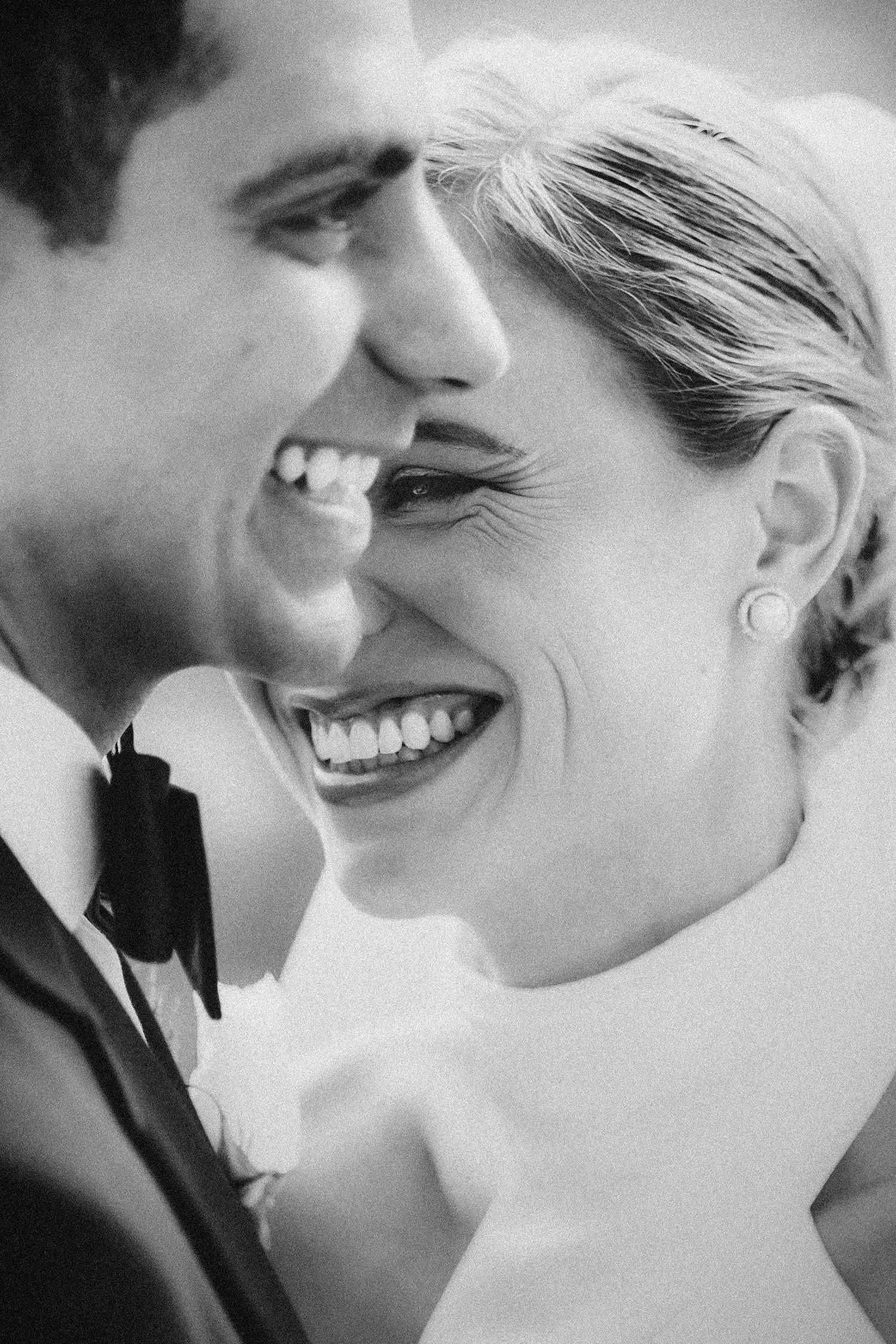 Black and white close-up photos of a joyful couple sharing intimate moments and laughter.