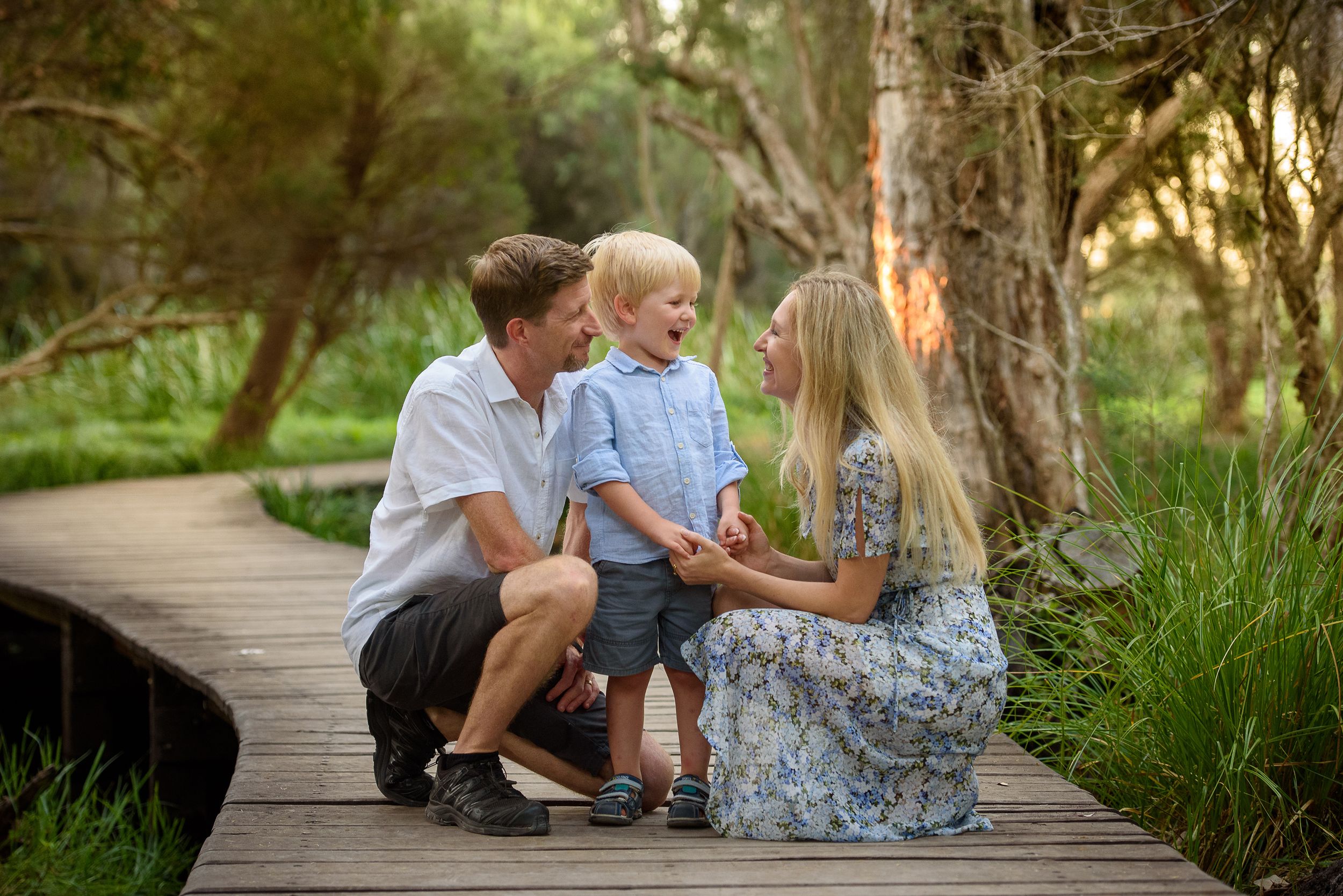 Family of three on a winding wooden path - Kelly Chapman Photographer Perth