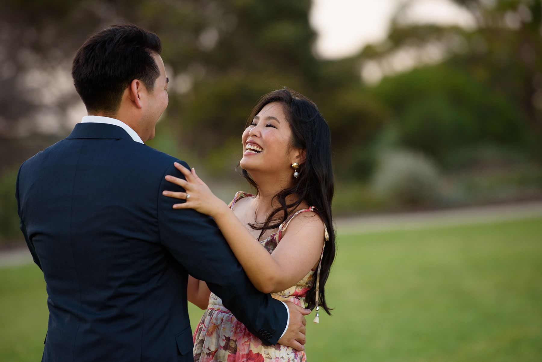 Portrait of a young loving engaged couple dancing in park - Kelly Chapman Photographer Perth