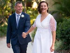 A bride holding hands with her husband on a meandering path - Kelly Chapman Photographer Perth