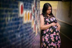 Pregnant woman looking down at her baby bump - Kelly Chapman Photographer Perth